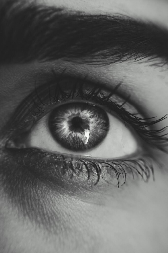 Detailed black and white macro shot of a human eye demonstrating intricate detail.